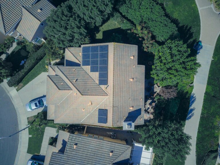 Aerial view of a home with a full solar panel installation