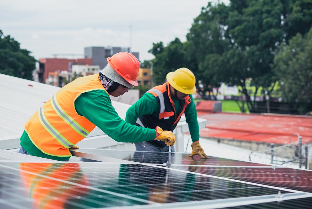 Solar technicians installing panels on a residential rooftop